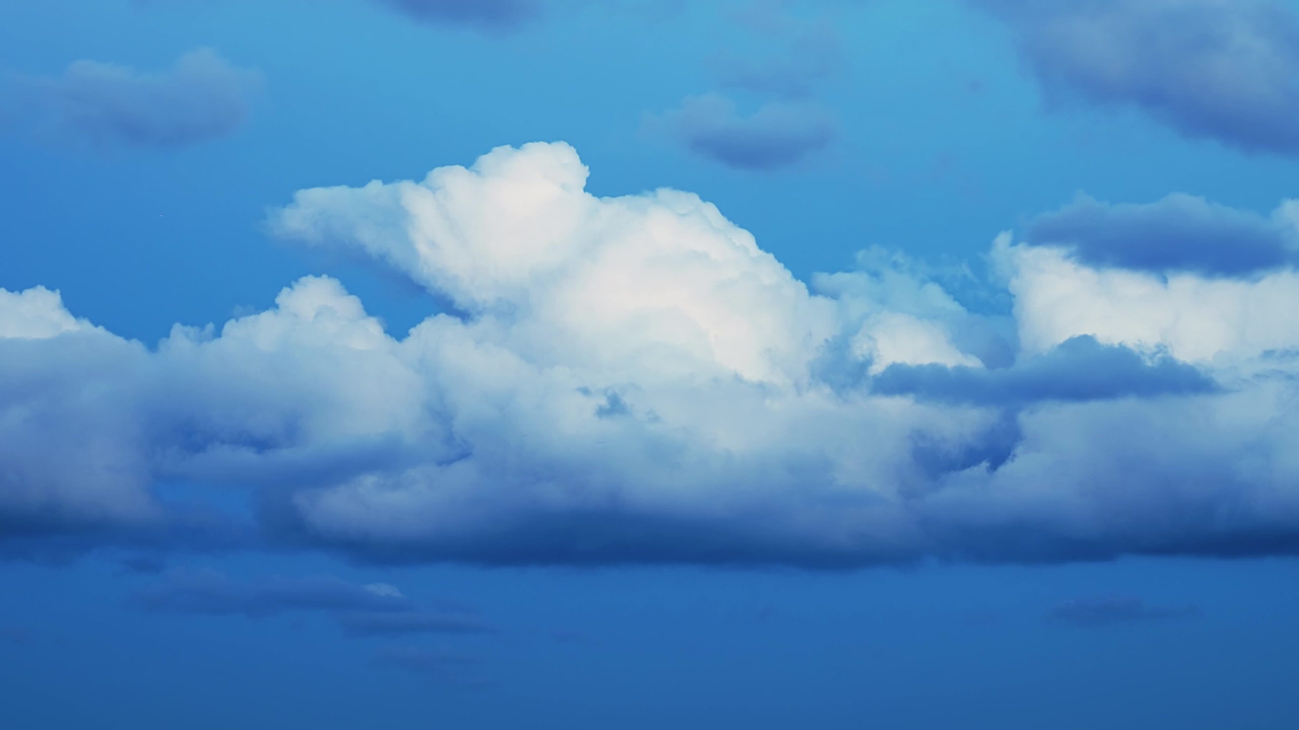 Amazing cumulus clouds group floats across colorful blue sky