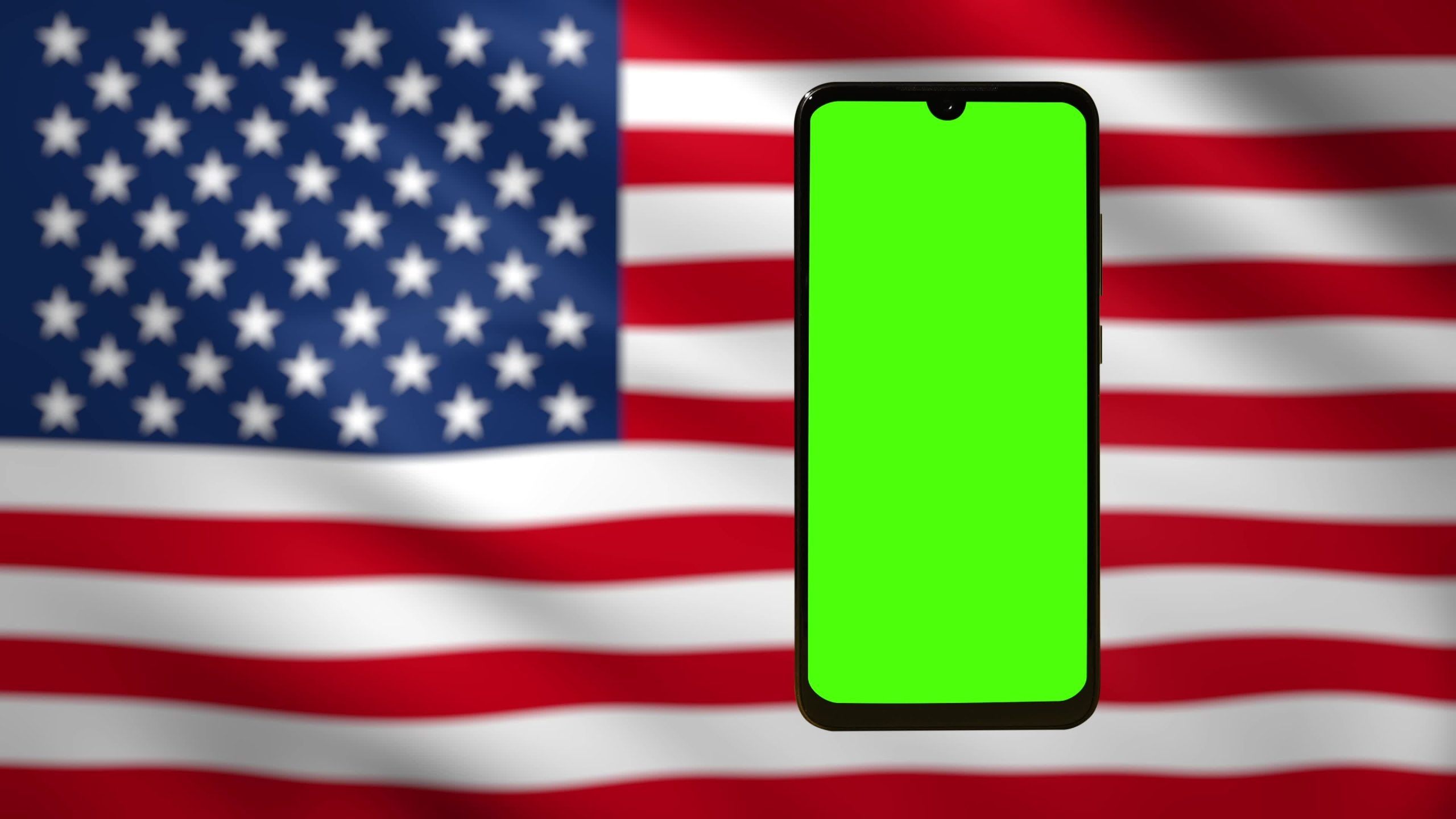 Telefono cellulare con schermo chromakey contro la bandiera americana