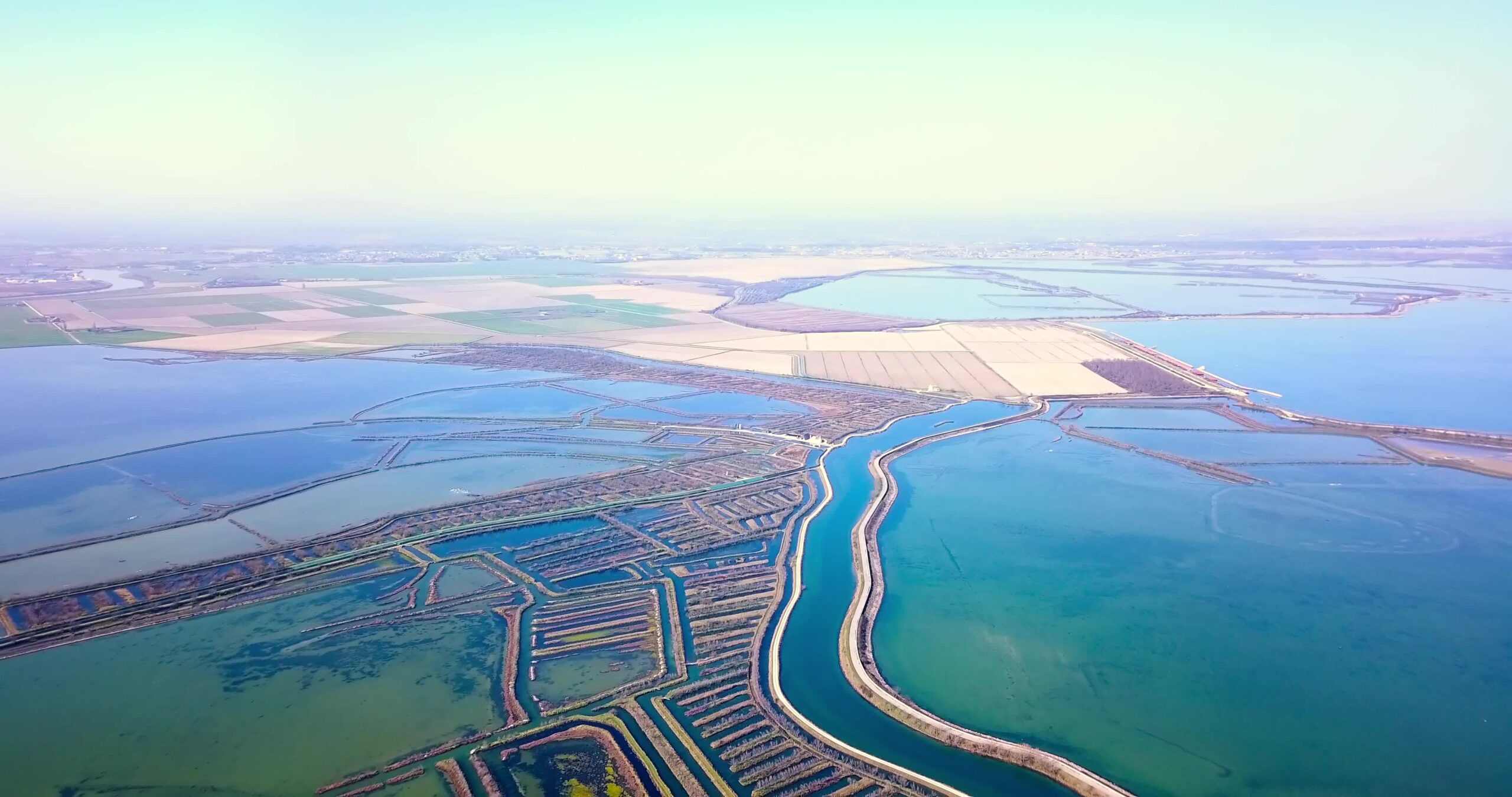 Boundless dry fields and colorful Venetian bays near polders