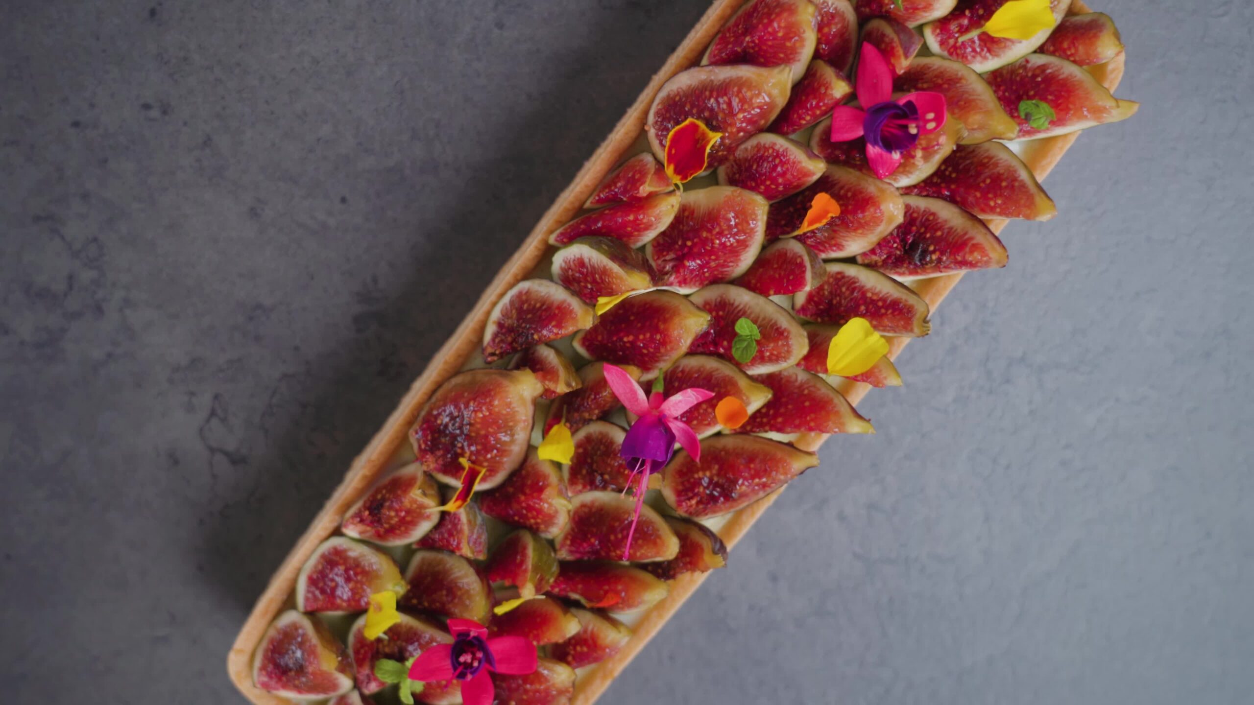 Biscuit with fig slices flowers and colorful leaves on top