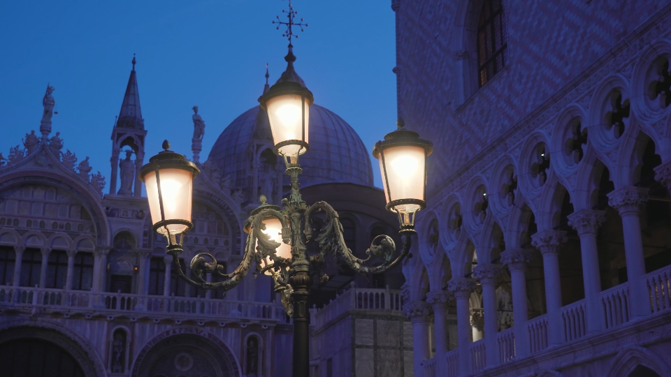 Ancient street lamp on Saint Mark Square against cathedral