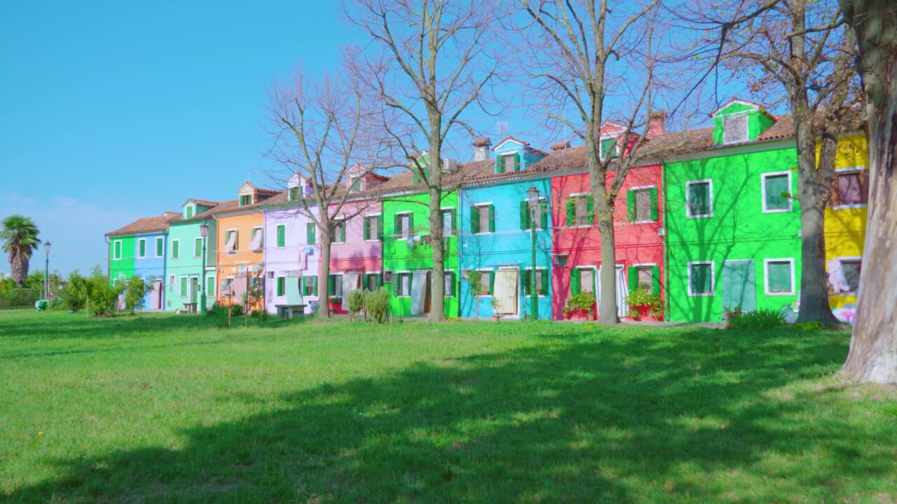 Case bifamiliari multicolori si trovano vicino al prato verde