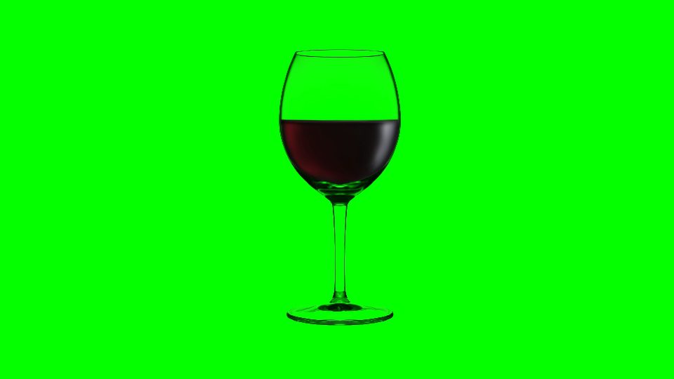 Bicchiere di vino si riempie di vino rosso su sfondo verde