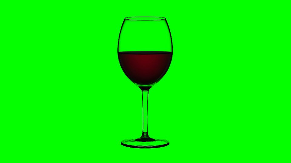 Empty glass fills up with red wine on green background