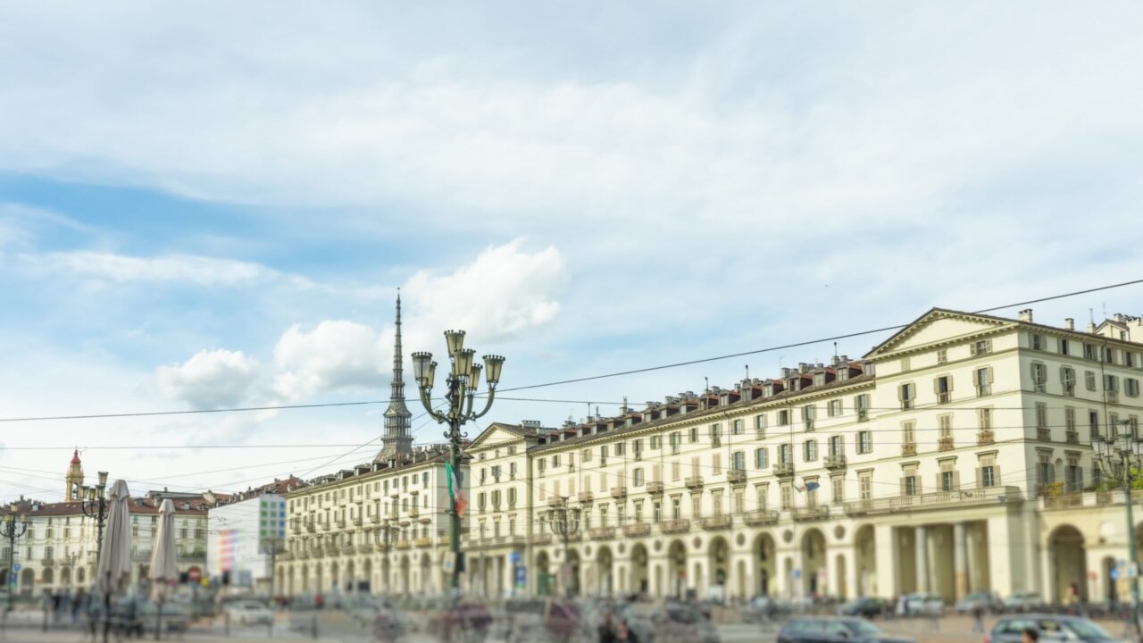 Busy central street of Turin with historical buildings
