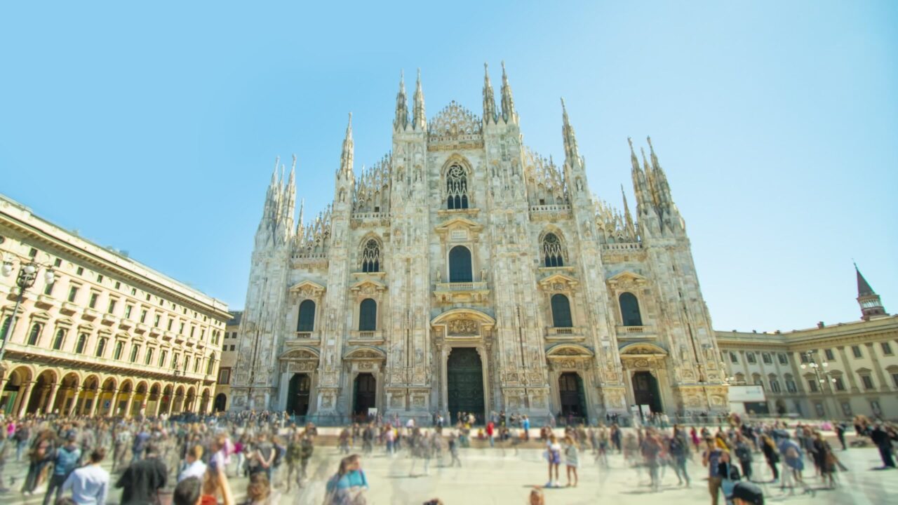Cathedral church and tourists on central square in Milan