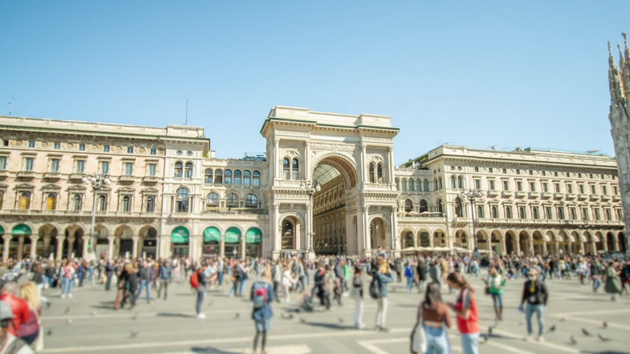 Historical building with arch at cathedral on Milan square