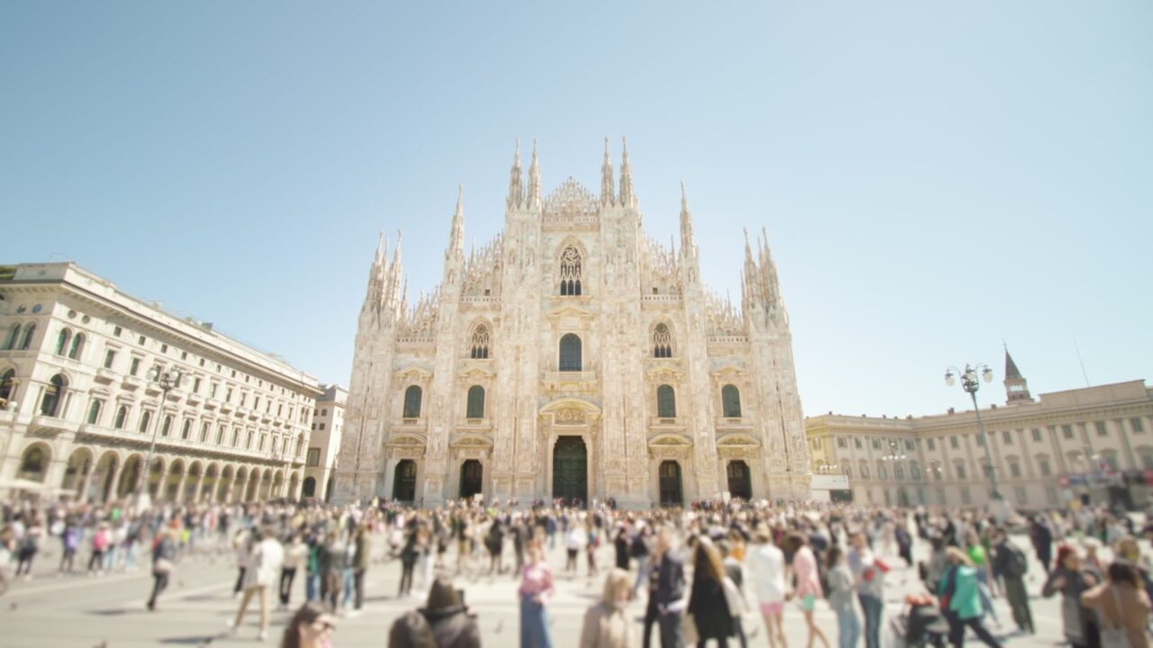 4K stock footage – People walk on square against Duomo in center of Milan