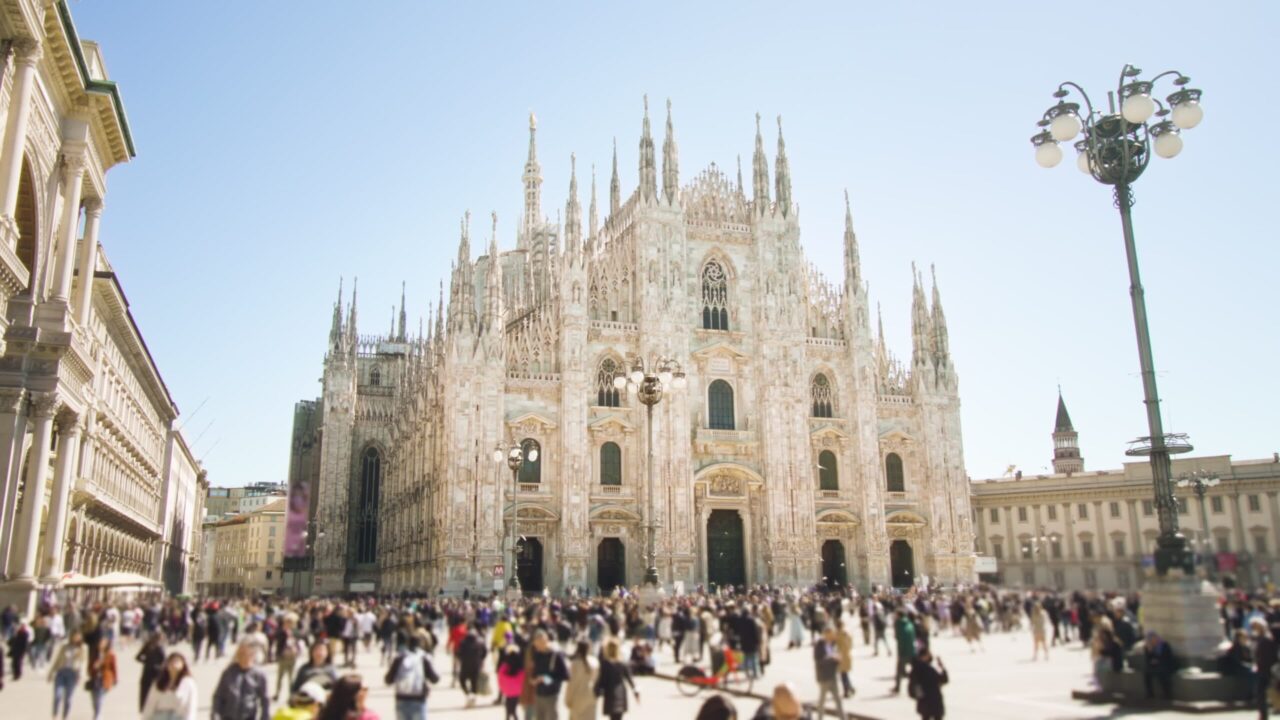 4K stock footage – People walk on crowded square against Duomo cathedral