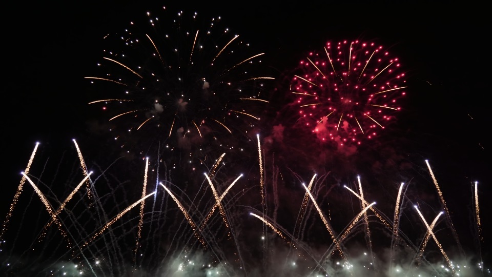 Red fireworks burst in air at Feast of Redeemer celebration