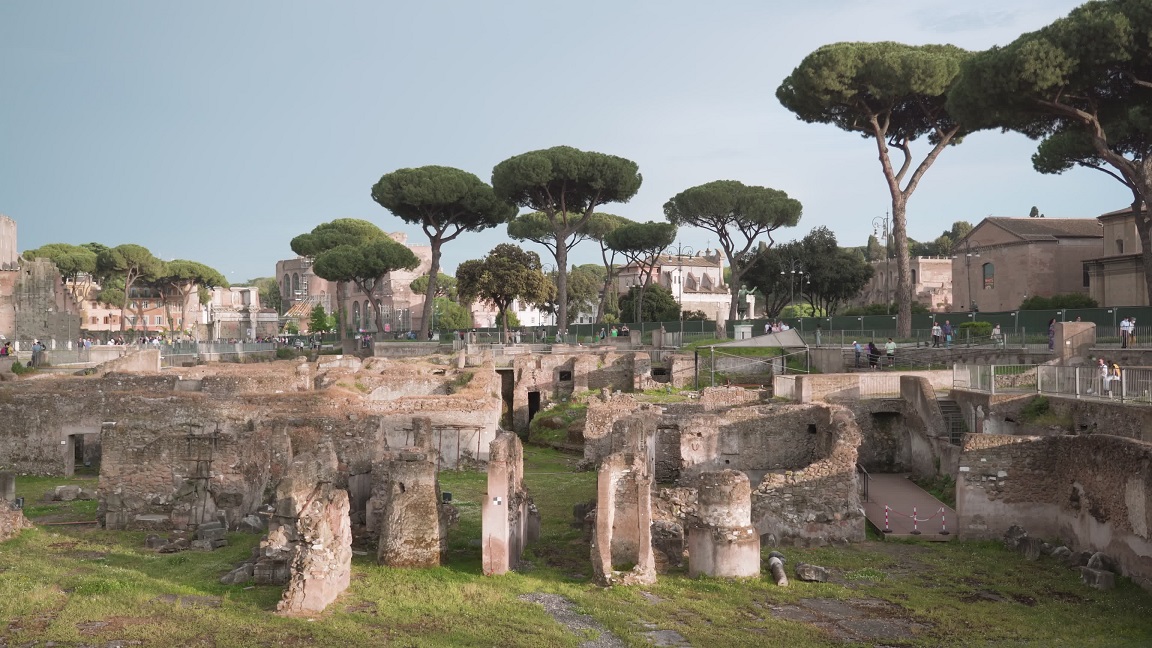 Ancient ruins of Antique Rome against exotic green trees