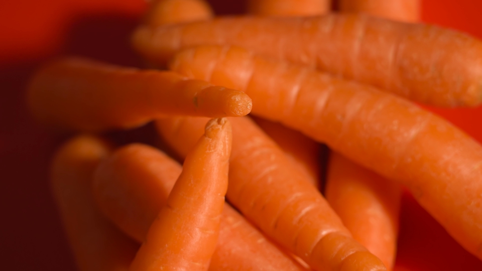 A bunch of carrots on the red table