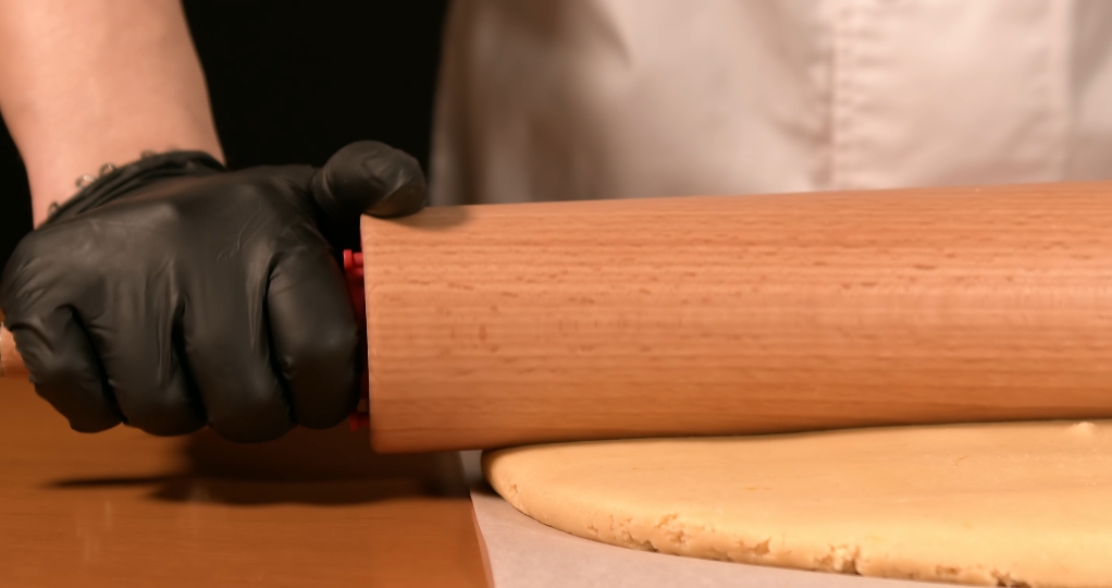 Dough is crushed with rolling pin