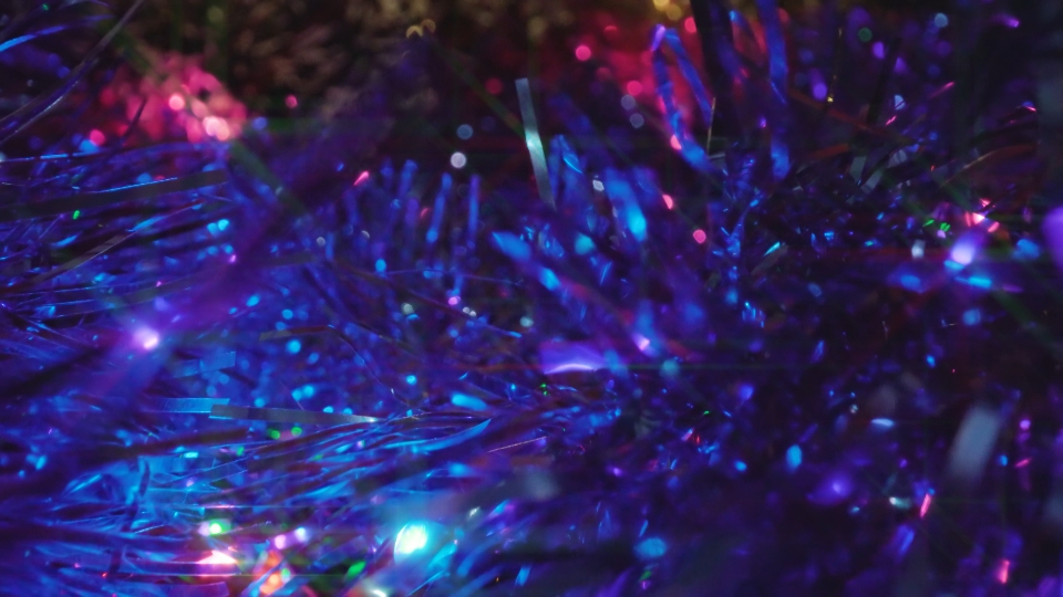 Motion above colorful Christmas tree tinsel ornaments