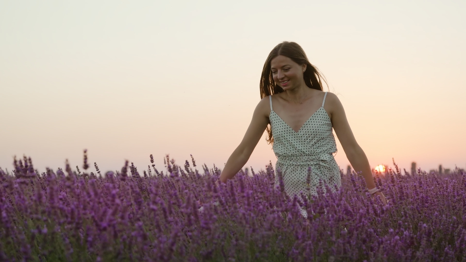 Happy woman runs among lavender