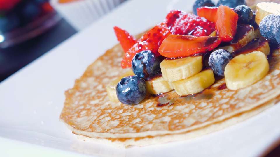 Pancakes with bananas and strawberries on top
