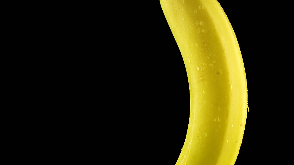 Banana wet with water on a black background