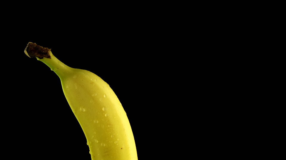 Banana wet with water on a black background