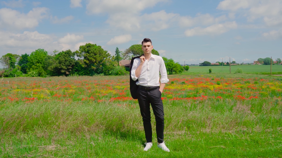 Boy dressed elegant with shirt on the poppy field