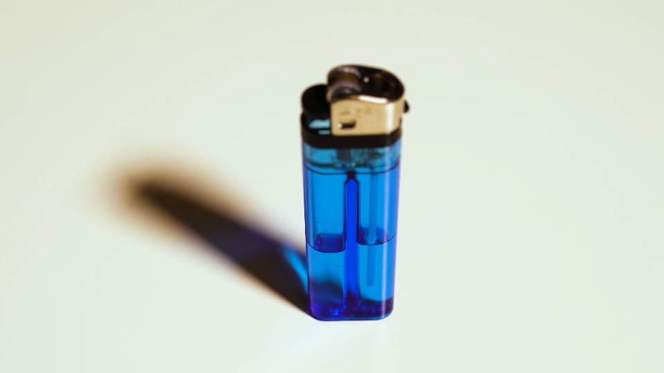 Blue lighter rotates on a white background
